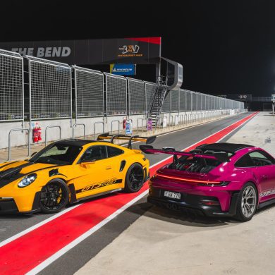 Image showing two 2024 Porsche 911 GT3 RS supercars, one in yellow and black and the other in purple.
