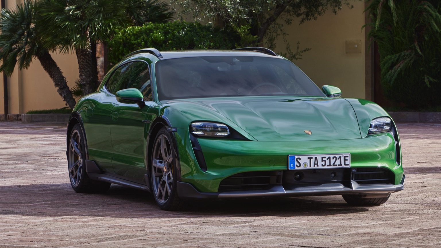 Front-angled view of a green Porsche Taycan Turbo Cross Turismo