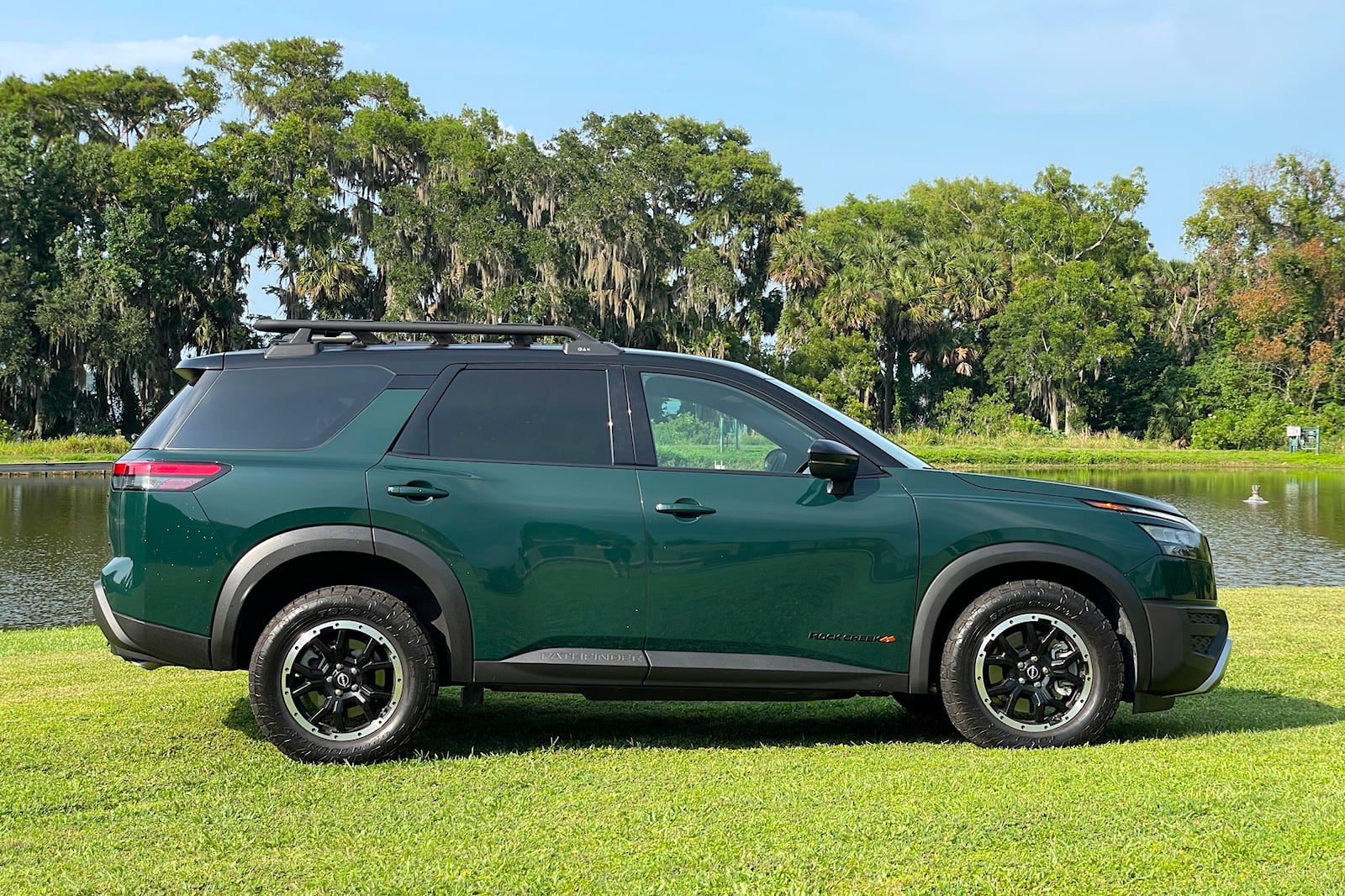 Side profile of a green 2024 Nissan Pathfinder