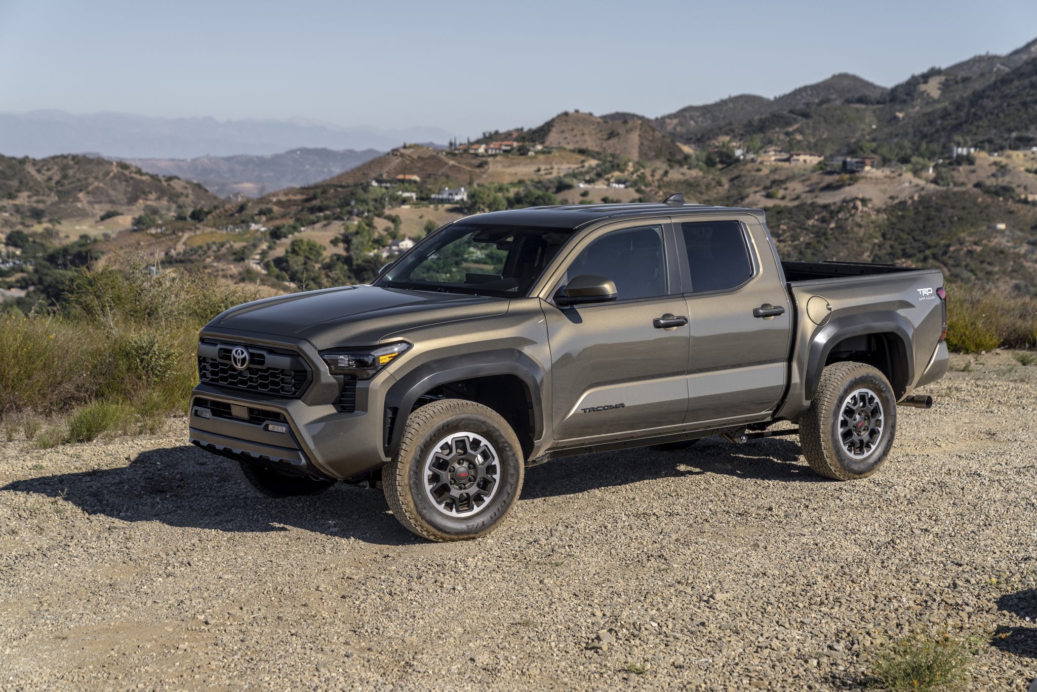 Side view of a 2024 grey Toyota Tacoma TRD Off Road on a trail