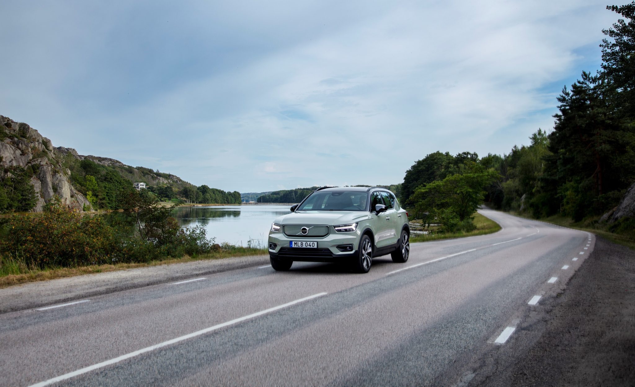 Front view of a 2024 green Volvo XC40 cruising